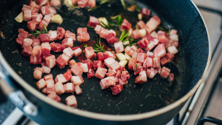 pancetta frying in pan