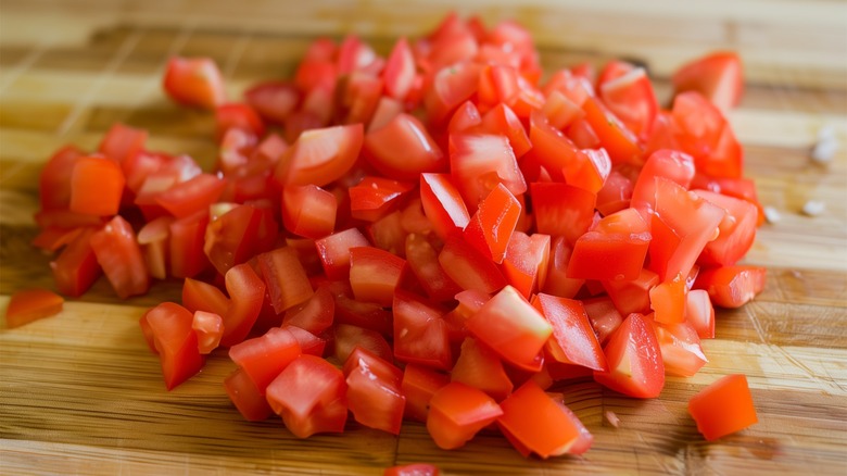 diced tomatoes on wood board