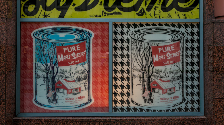 Maple syrup cans on sign