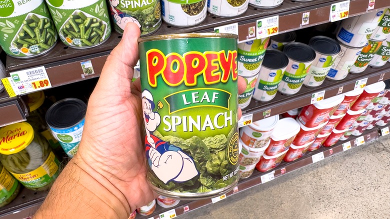 hand holding canned spinach