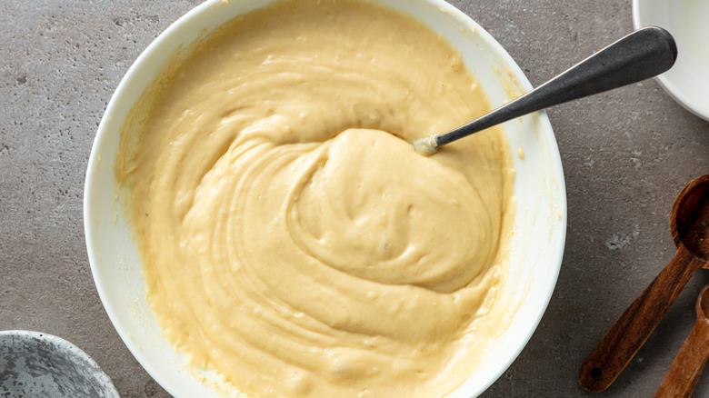 Pancake batter in white bowl with spoon