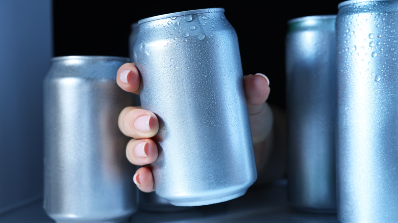 Person grabbing can out of fridge