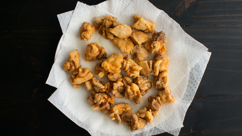 Small pieces of fried fish on paper towels