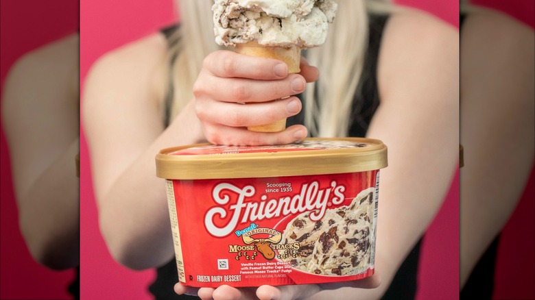 woman holding tub of Friendly's ice cream 