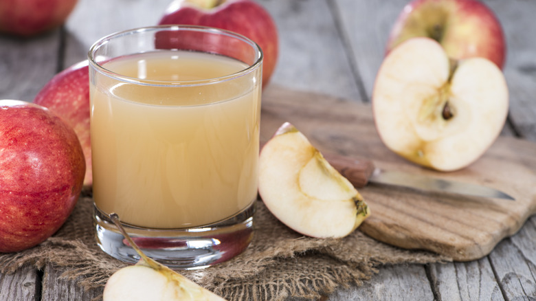 Glass of apple juice with apples