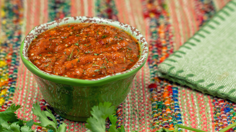 Green bowl of salsa with cilantro