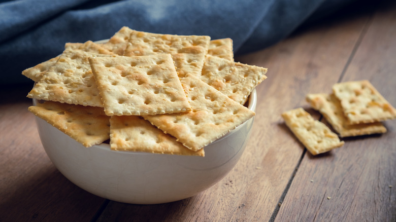 Saltines in a bowl on a wood table