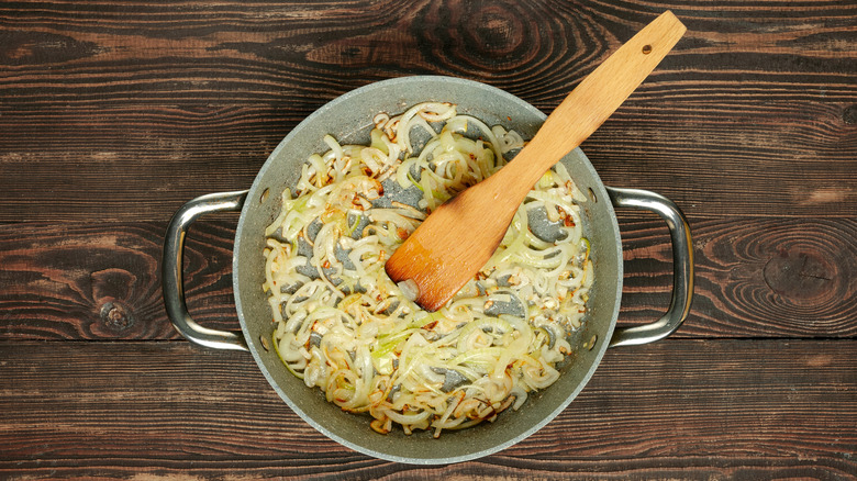 Cooked sliced onions in a skillet