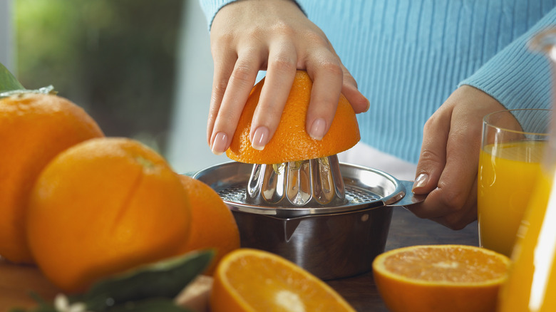 Hand juicing oranges