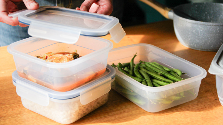 Person in kitchen putting away leftovers