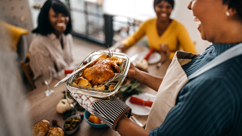 Woman serving food to family