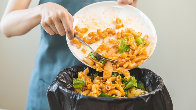 scraping a plate of food