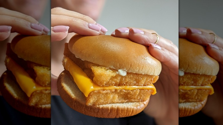 holding double Filet-O-Fish