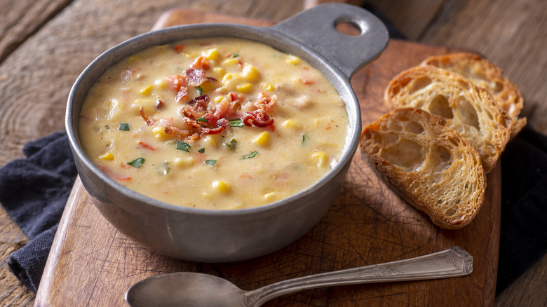 Corn chowder with spoon and toast