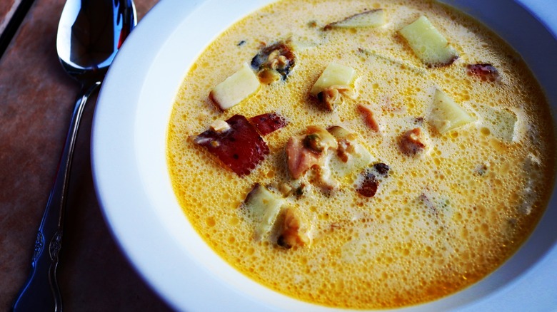 Maine clam chowder in white bowl with spoon