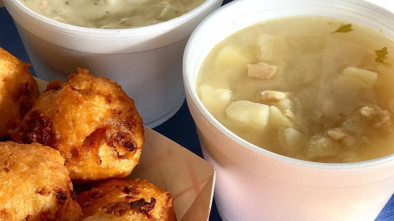 Cup of Rhode Island clam chowder next to hushpuppies