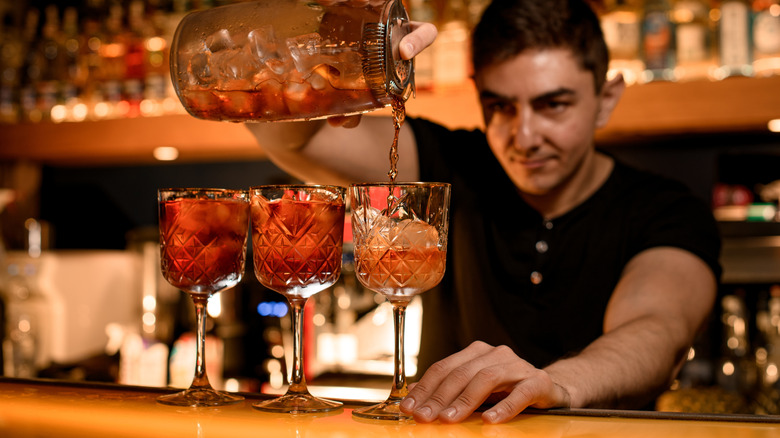 A bartender pours cocktails with classic style