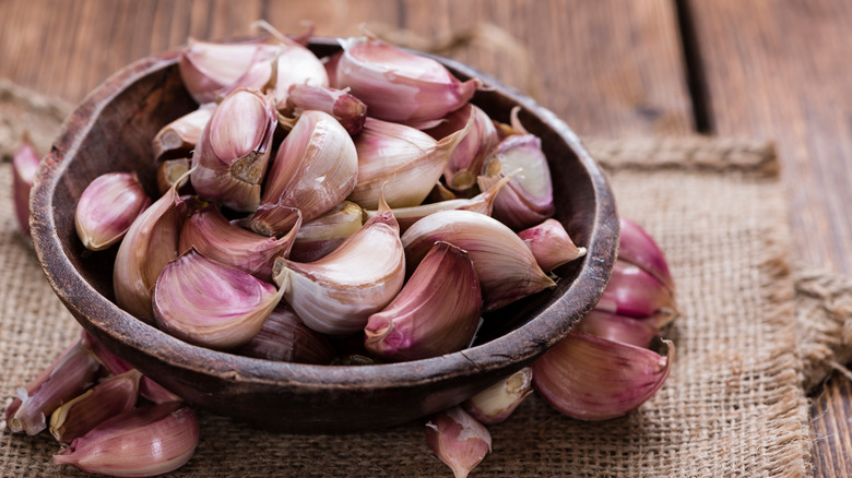 Garlic cloves in wooden ramekin