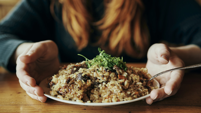 Woman with seasoned rice on the table