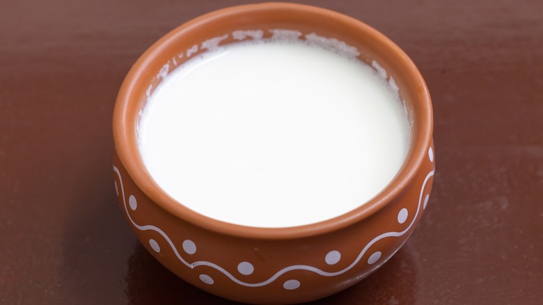 Picture of milk in small brown ramekin