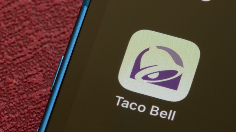 Taco Bell app icon on mobile phone