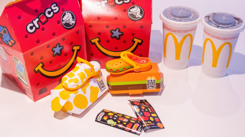 Two Happy Meal boxes with toys on white table