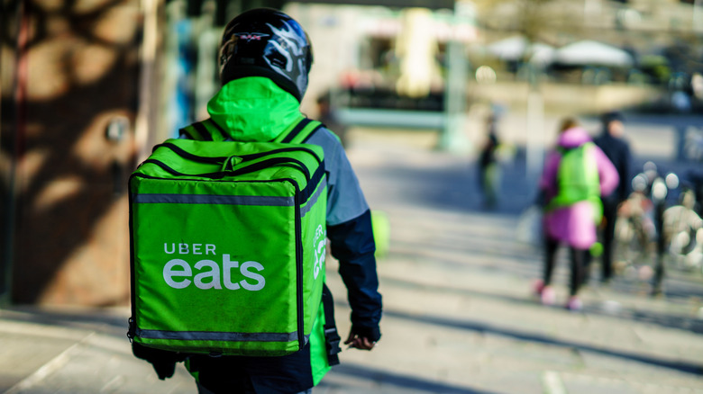 Person with Uber Eats backpack walks down street