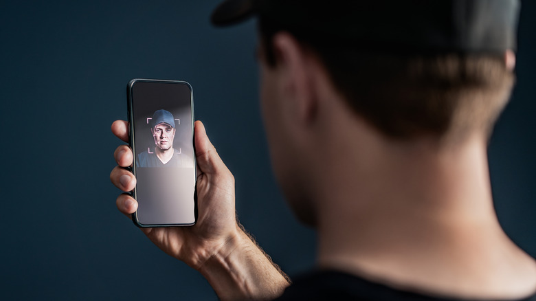 Person using facial recognition software on phone