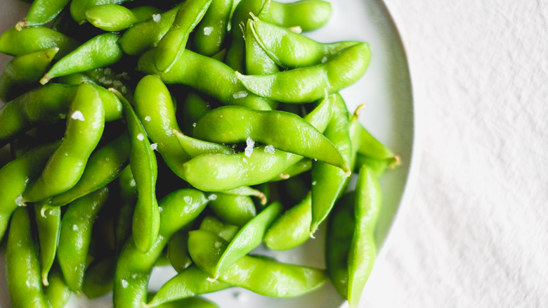 A plate of edamame sprinkled with salt