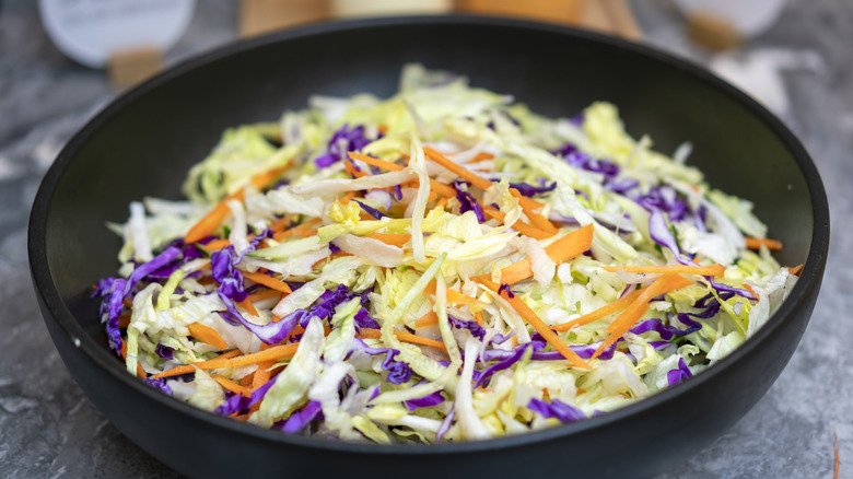 Coleslaw mix in a black bowl