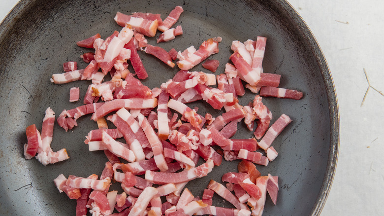 Uncooked lardons on a metal pan