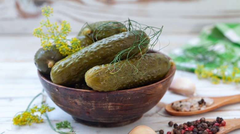 A bowl of pickles and pickling ingredients