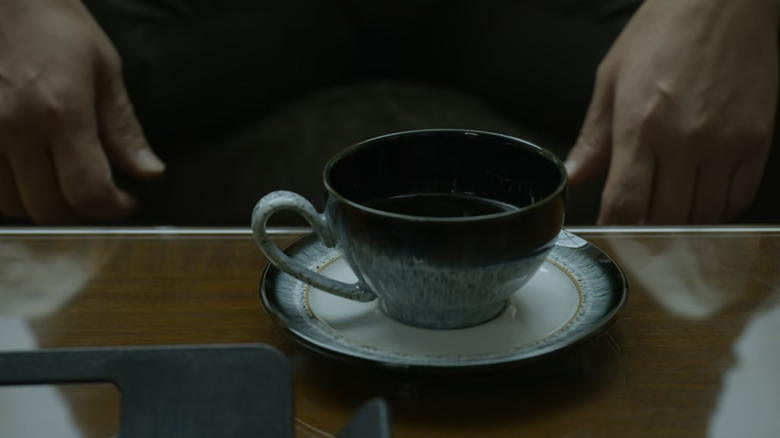 A single cup of coffee placed on a saucer