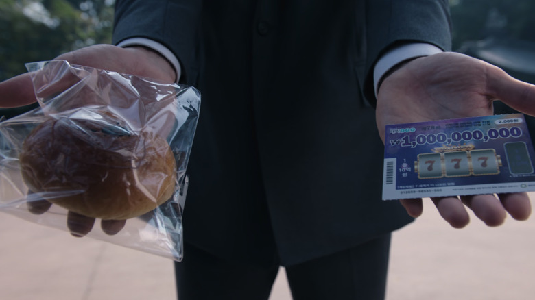 The recruiter holds a roll and a lottery card in each hand