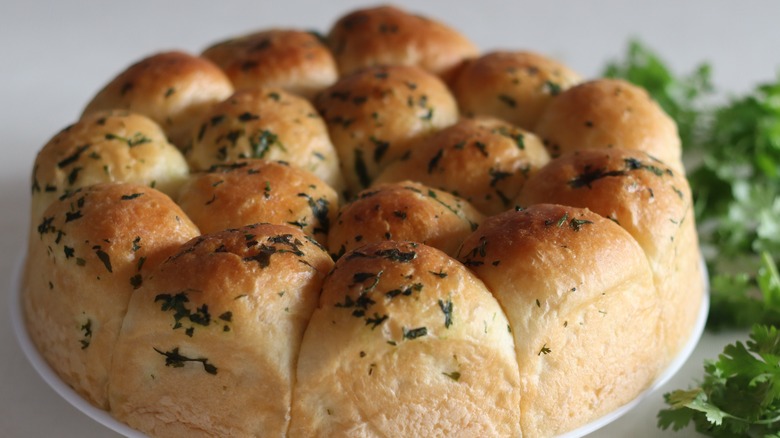 Plate of glazed and seasoned dinner rolls