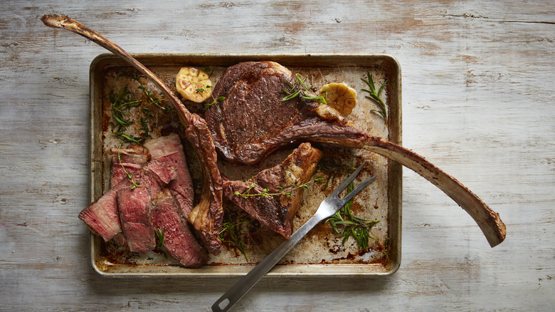 Tomahawk steak on baking sheet