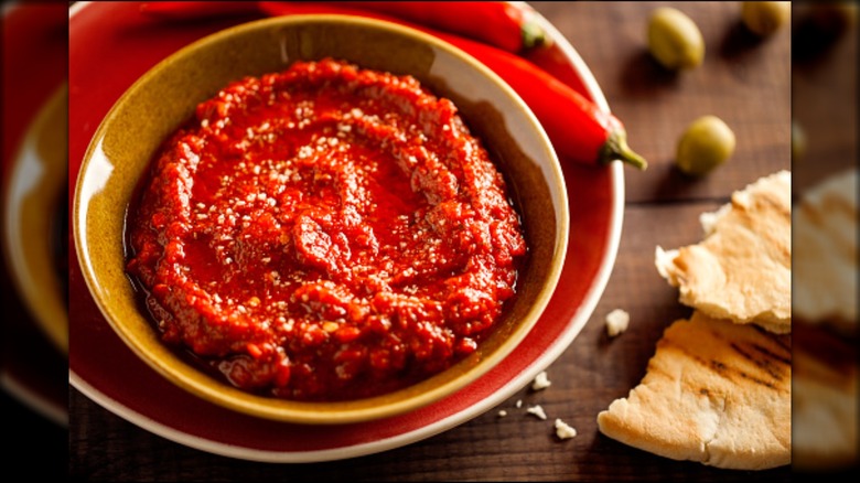 Harissa in bowl next to pita