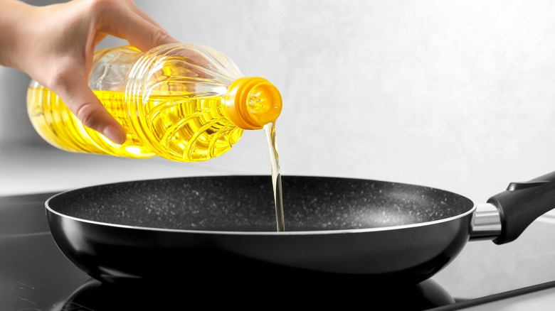 Pouring oil into pan