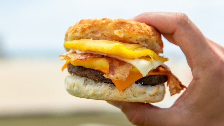 A handheld Carl's Jr. Monster Biscuit