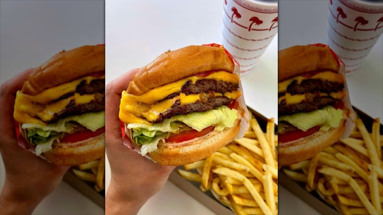 Person holding In-N-Out Double Double with Onion