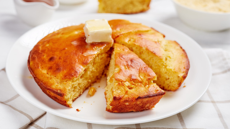 Butter melting on a plate of cornbread