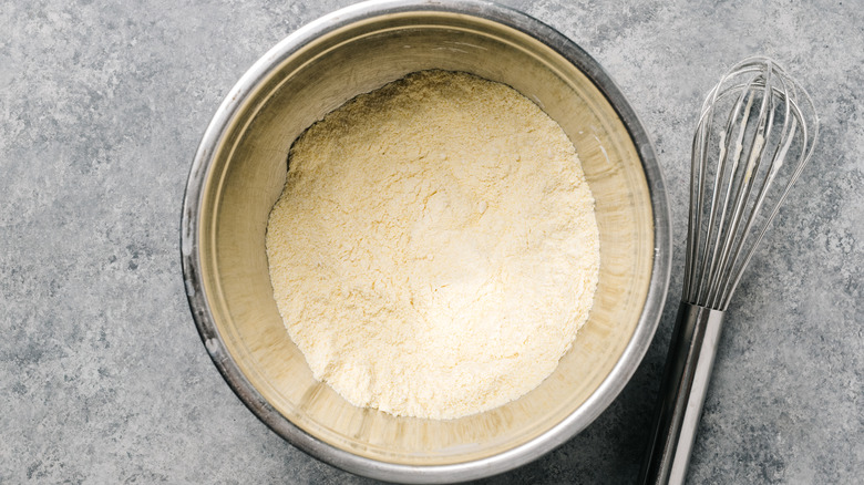 Cornmeal and flour mixture in bowl with whisk