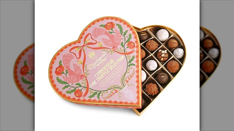 chocolates in a pink heart-shaped box decorated with birds and flowers