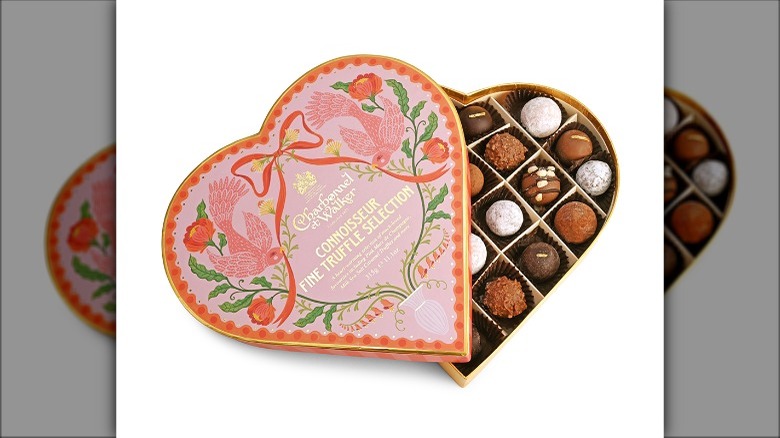 chocolates in a pink heart-shaped box decorated with birds and flowers