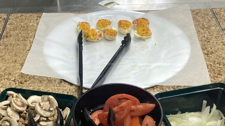 deviled eggs beside salad ingredients