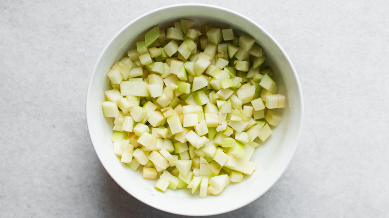 Diced apples in white bowl