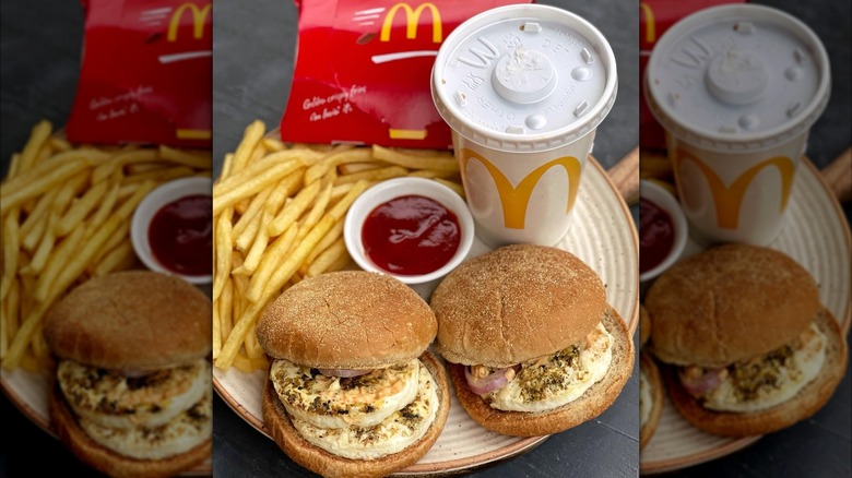 Two Masala McEgg Burgers on a plate with fries and drink