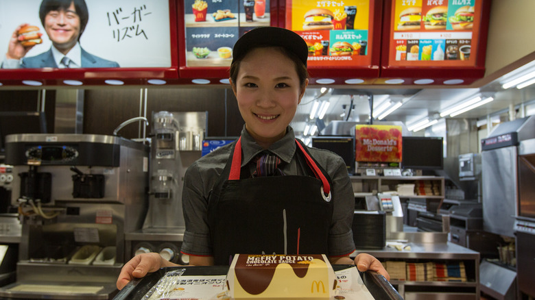 McDonald's employee offering food in Japan