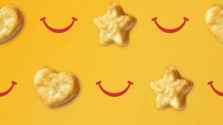 Chicken nuggets shaped like stars and hearts on yellow background