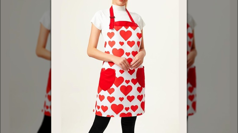 A person wearing the Love Potato Adjustable Hearts Kitchen Apron